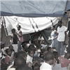 Jean-Robert speaks to Haitians in tent camps to sensitize them to the needs of children in restavek.
